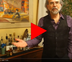 still from a video showing a bartender holding his arms wide